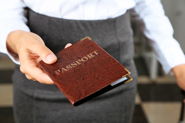 Woman holding passport close up