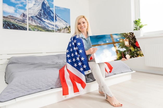 woman holding a photo canvas with a picture of christmas.