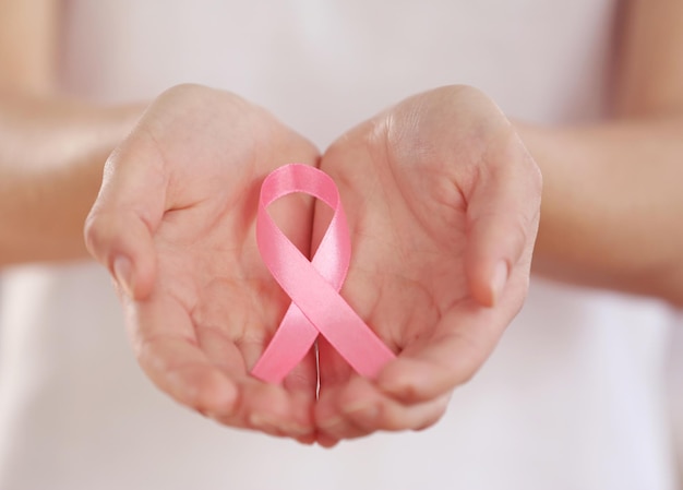 Woman holding pink ribbon Cancer concept