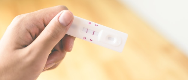 Woman holding pregnancy test. 