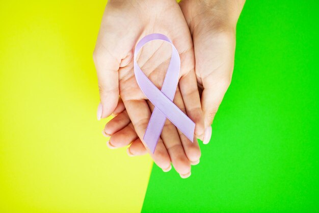 Woman holding purple ribbon domestic violence awareness