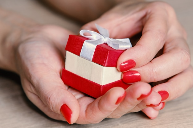 Woman holding red gift box