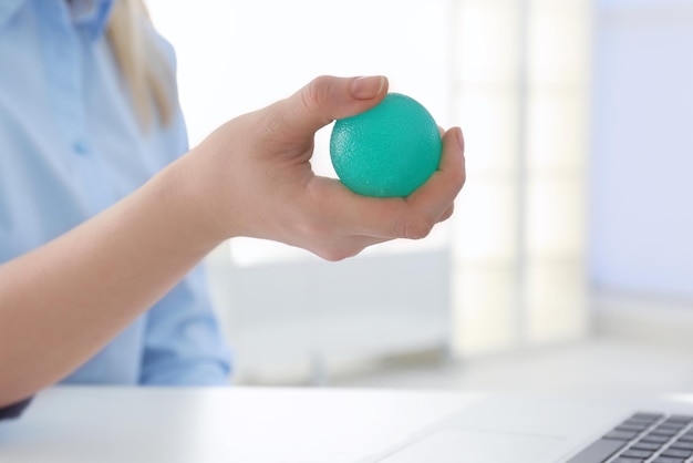 Woman holding rubber ball at work space