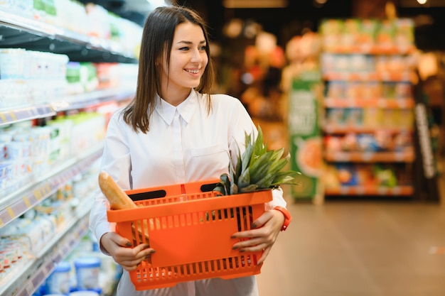 Woman holding a shopping bag of fresh food