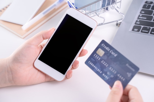 Woman holding a smart mobile phone for electronic payment shopping