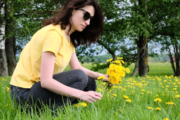 Woman holding some yellow flowers