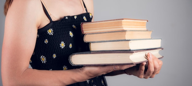 Woman holding stack of books