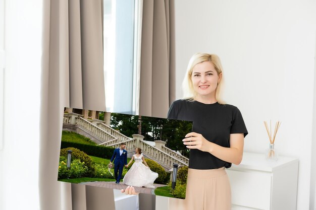 Woman holding wedding photography photo canvas print with gallery wrap.