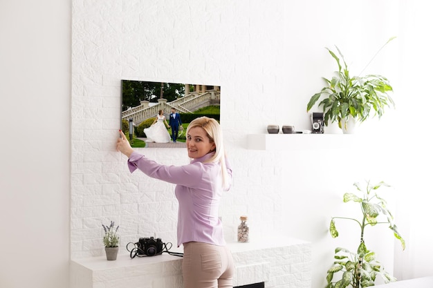 Woman holding wedding photography photo canvas print with gallery wrap.