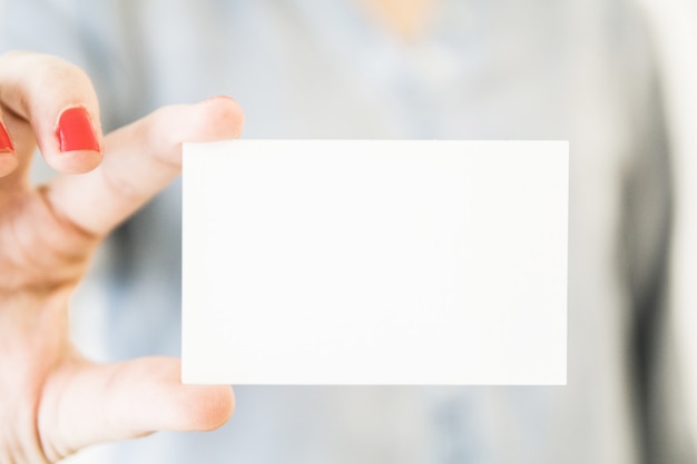 Woman holding white blank business card