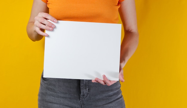 Woman holding white empty sheet of paper