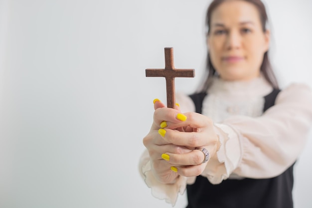 Woman holding a wooden cross Praying for God Religion