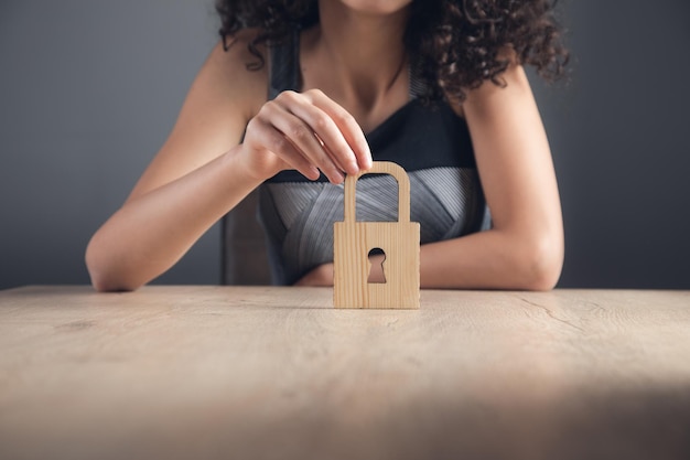 Woman holding wooden lock sign