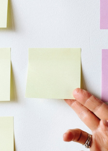 Woman holding a yellow sticky note