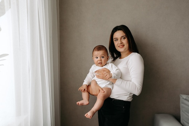 A woman holds a baby in her arms.