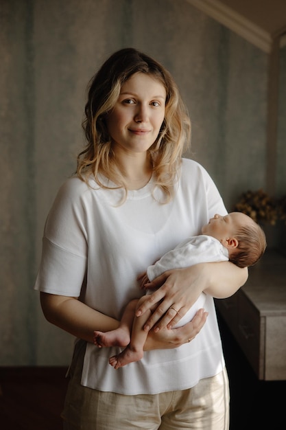 a woman holds a baby and holds her hand in her arms