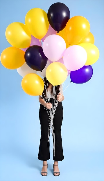 Photo a woman holds a bunch of balloons with the word quot i love quot on the bottom