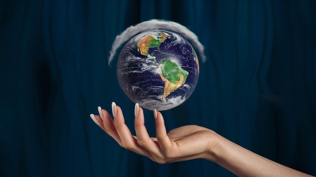 a woman holds a globe with the word earth on it