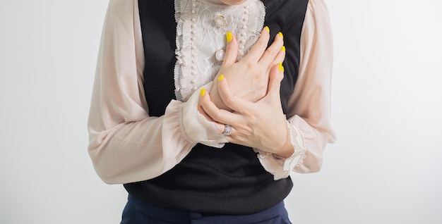 A woman holds her chest in pain.