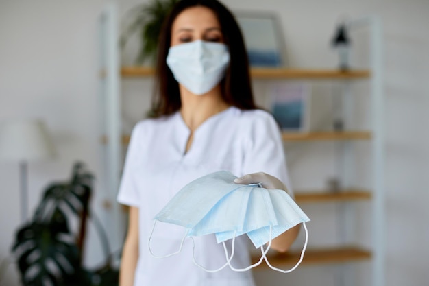 A woman holds medical masks in her hands to prevent colds or viruses