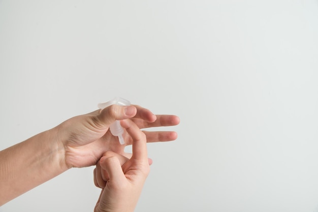 the woman holds a menstrual cup in her hands