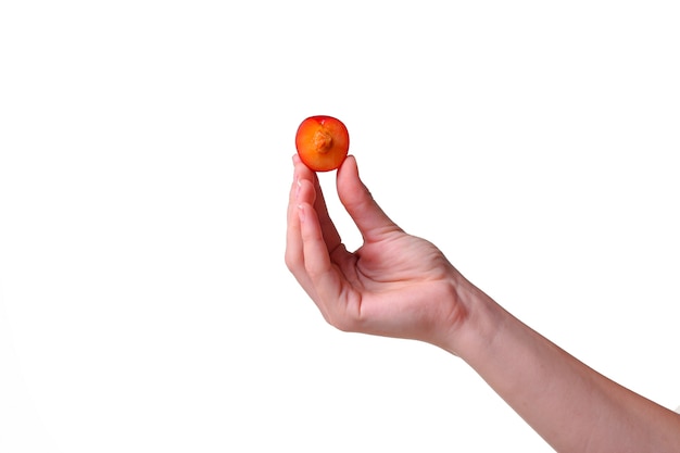 Woman holds plum in hands on an isolated white background. idea and concept of healthy eating