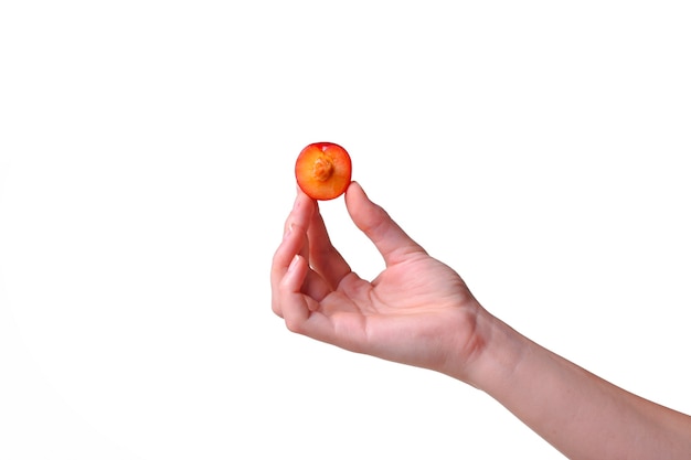 Woman holds plum in hands on an isolated white background. idea and concept of healthy eating