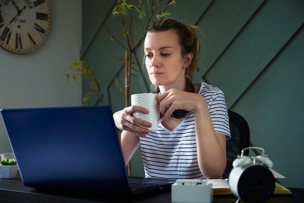 Woman at home office workplace using laptop female freelancer working at living room