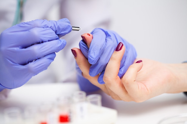 Woman at the hospital submits a blood test for a coronavirus