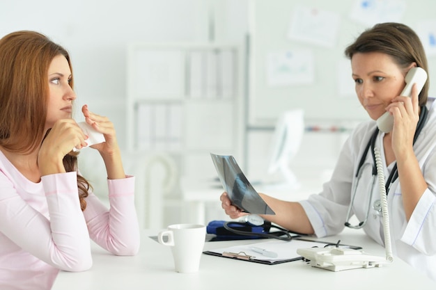 Woman in hospital with caring doctor