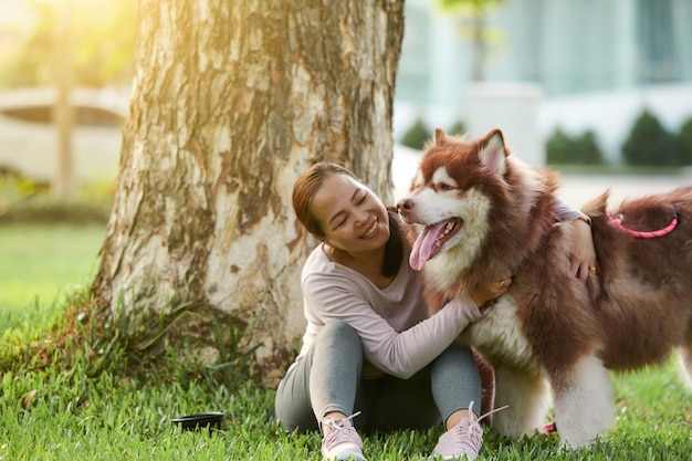 Woman Hugging Fluffy Dog