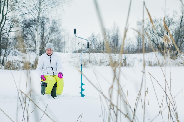 Woman ice-fishing in the winter.