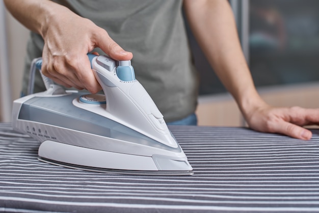 Photo woman ironing clothes with modern iron