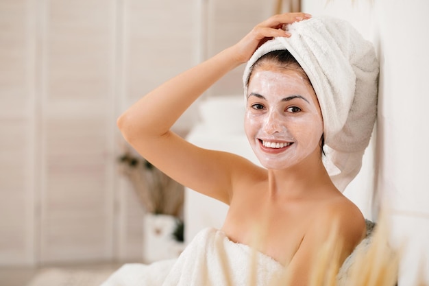 Woman is applying mask on her face