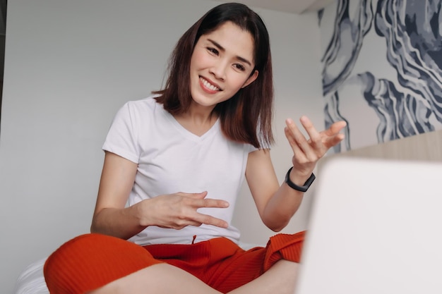 Woman is attending a conference in a hotel room concept of workation