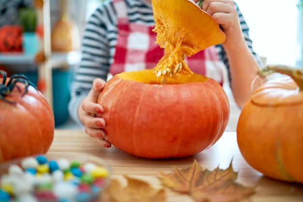 Woman is carving pumpkin