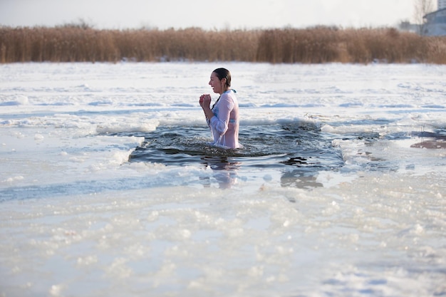 A woman is dipped in cold water