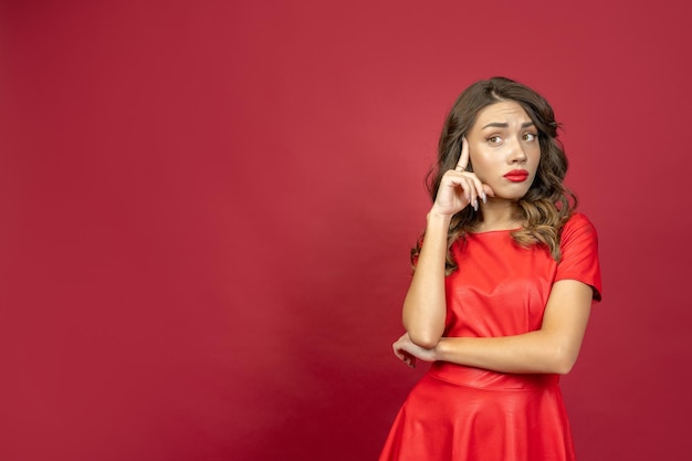 Woman is disappointed on a red background