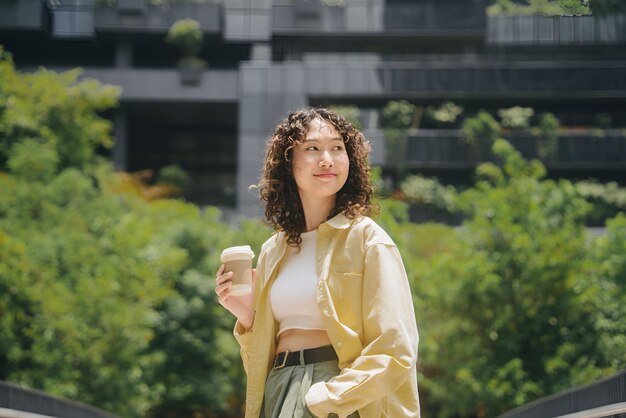 a woman is drinking from a cup of coffee