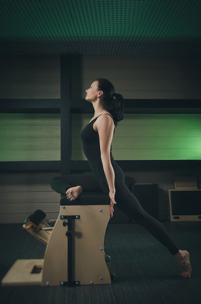 A woman is engaged in Pilates. fitness and sports