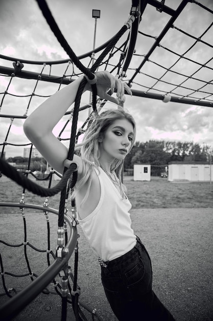 A woman is hanging on a net with the word " on it "