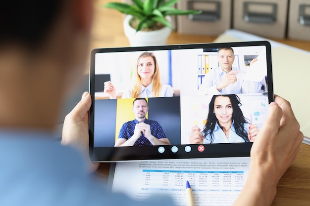 Woman is holding online conference via tablet remote work and briefing concept