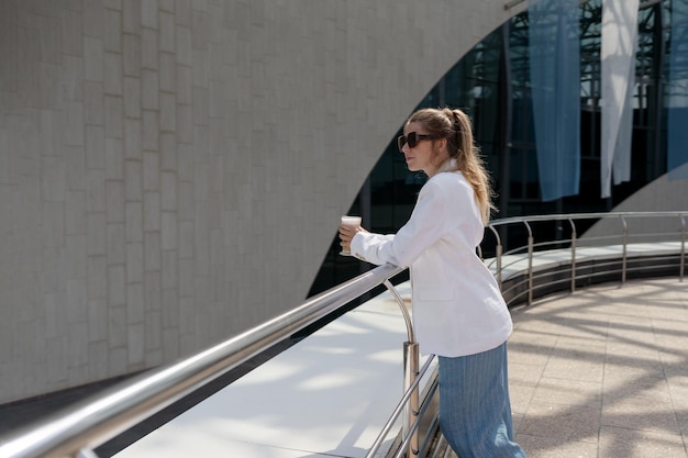 Photo a woman is looking down on an escalator