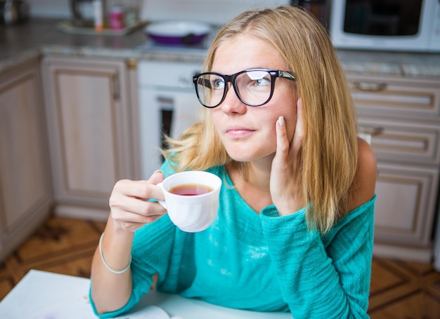 Woman is lost in thought and drinking coffee