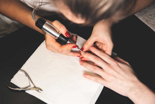 Woman is making a manicure Salon procedures at home Beautiful hands and nails