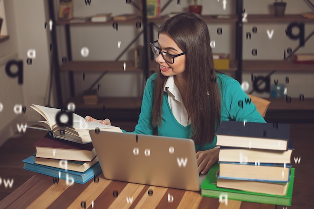 Woman is opened a book She is working with lots of books and laptop at the wood table