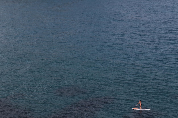 Woman is practicing Paddle Surf in Cabo de Gata