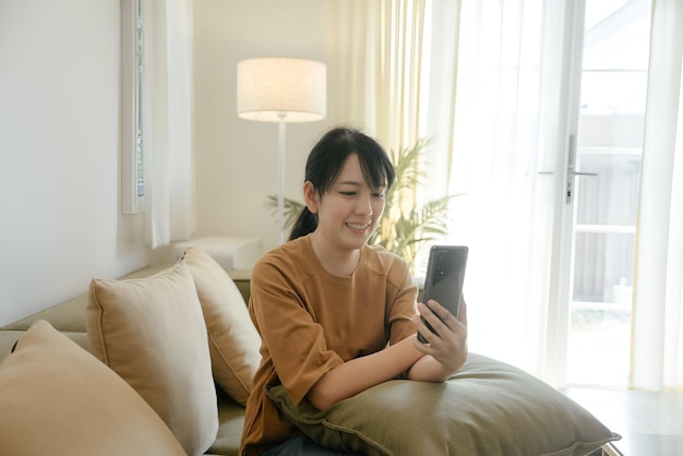 a woman is sitting on a couch with a book in her hands