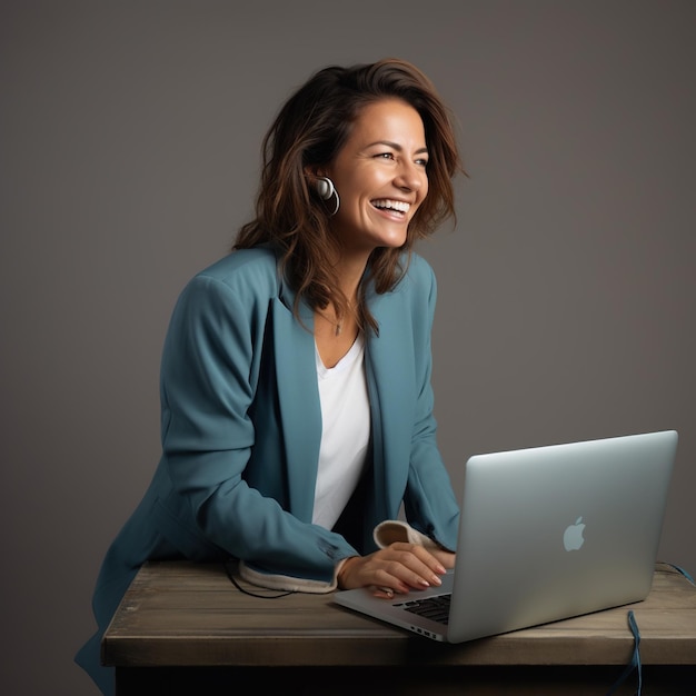 a woman is sitting at a desk with a laptop and a phone