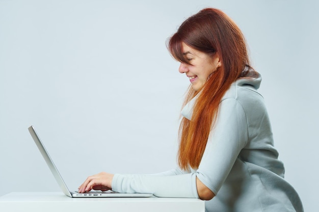 Woman is sitting at table and using laptop for communication in chat or video chat Social media concept